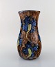 Roskilde Lervarefabrik, Denmark. Large art nouveau vase in glazed ceramics. Blue 
flowers in brown base. Dated 1915-1921. 
