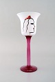 Ulrica Hydman Vallien for Kosta Boda. Hand painted wine glass in mouth blown art 
glass decorated with woman