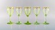 Emile Gallé (1846-1904). Fem tidlige og sjældne vinglas i mundblæst lysegrønt 
kunstglas med håndmalede guldekorationer i form af blade. Museumskvalitet, 
1870/80