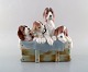 Lladro, Spain. Large figure in glazed porcelain. Four puppies in a basket. 
1980
