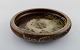 Carl Halier for Royal Copenhagen. Round dish in glazed ceramics. Beautiful sung 
glaze. Mid 20th century.
