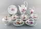Meissen, Germany. Pink rose coffee service for five people in hand-painted 
porcelain. With coffee pot, cream jug, sugar bowl and plates. Early 20th 
century.
