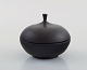 Isak Isaksson, Swedish ceramist. Unique lid jar in black glazed stoneware.
