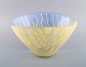 Monica Backström (1939-2020) for Kosta Boda. Large bowl in yellow and blue art 
glass with striped design. 1980 / 90s.
