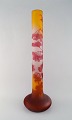 Emile Gallé vase in frosted / yellow and overlaid red art glass carved with 
motifs in the form of berries and leaves. Ca. 1910.
