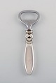 Georg Jensen Cactus bottle opener in sterling silver and stainless steel.
