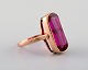 Vintage art deco ring in 14 carat gold adorned with large violet semi-precious 
stone. 1940