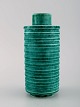 Wilhelm Kåge for Gustavsberg. Rare cylindrical Argenta art deco vase in glazed 
ceramics. Beautiful glaze in shades of green and grooved body. 1940