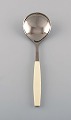 Henning Koppel for Georg Jensen. Strata serving spoon in stainless steel and 
cream-colored plastic. 1960 / 70s. 2 pcs in stock.
