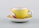 Antique and rare Meissen coffee cup with saucer in hand-painted porcelain with 
young boys. Purple on yellow background. Dated 1773-1814. Museum quality.
