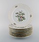 8 Royal Copenhagen "Spring" porcelain dinner plates with motifs of birds and 
foliage. 1980s. Model Number: 1533/2516.
