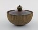 Arne Bang, Denmark. Jar in glazed ceramics with bronze lid. Beautiful glaze in 
light earth tones. 1940s.

