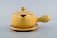 Vicke Lindstrand for Uppsala Ekeby. Sauce boat on saucer in glazed stoneware. 
Beautiful yellow glaze. 1950
