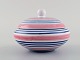 Ingrid Atterberg for Uppsala Ekeby. Lidded jar in glazed stoneware. Striped 
design in blue and pink shades. Dated 1951-52.
