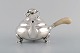 Early Georg Jensen "Blossom" teapot of hammered sterling silver. 
Handle in ivory. Pattern 2C. Dated 1925-30.