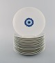 Bjørn Wiinblad for Rosenthal. 15 Romanze lunch plates in white porcelain with 
blue decoration. 1980s.
