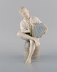 Bing & Grondahl porcelain figure. Boy with accordion. 1950s. Model Number: 1661.
