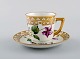 Royal Copenhagen coffee cup with saucer in hand-painted porcelain with gold 
decoration and flowers. Flora danica style, 1960s.
