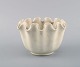 Wilhelm Kåge for Gustavsberg. Carrara vase / bowl with wavy edge in sand colored 
ceramics.
