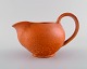 Svend Hammershøi (1873-1948) for Kähler. Jug in glazed ceramics. Beautiful 
orange uranium glaze. 1930 / 40s.
