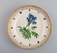 Royal Copenhagen Flora Danica plate in hand-painted porcelain with flowers and 
gold decoration. Dated 1952.
