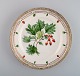 Royal Copenhagen Flora Danica plate in hand-painted porcelain with flowers and 
gold decoration. Dated 1949.
