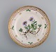 Royal Copenhagen Flora Danica plate in hand-painted porcelain with flowers and 
gold decoration. Dated 1952.
