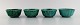 Wilhelm Kåge for Gustavsberg. Four Argenta art deco bowls in glazed ceramics. 
Beautiful glaze in shades of green. 1950/60