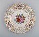 Dresden dinner plate in openwork porcelain with hand-painted flowers and gold 
decoration. 1920s.
