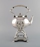 Tiffany & Company (New York). Tea service in sterling silver. Swing kettle with 
stand. Classicist style, late 19th century.
