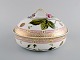 Early Royal Copenhagen Flora Danica porcelain lidded tureen, decorated in colors 
and gold. Branches with repousse flowers in relief. Dated 1918.
