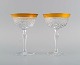Two champagne glasses in mouth-blown crystal glass with gold edge. France, 
1930s.
