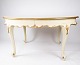 Rococo dining table of white painted wood decorated with leaf gold, and with 
three extension plates, from the 1890s.
5000m2 showroom.
