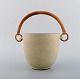 Arne Bang (1901-1983), Denmark. Ice bucket in glazed ceramics with handle in 
wicker. Model number 15. Beautiful glaze in sand shades. 1940s / 50s.
