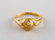 Scandinavian jeweler. Vintage ring in 22 carat gold adorned with three 
semi-precious stones. Mid-20th century.
