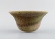 European studio ceramicist. Unique bowl in glazed stoneware. Beautiful glaze in 
green and light earth shades. Dated 1982.
