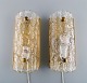 Carl Fagerlund for Orrefors. A pair of wall lamps in clear art glass and brass. 
Swedish design, 1960s.
