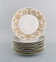 Bjørn Wiinblad for Rosenthal. 10 dinner plates in porcelain with gold 
decoration. 1980s.
