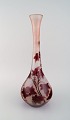 Legras, France. Large vase in red and frosted art glass in violet tones carved 
with motifs in the form of foliage. 1920s.
