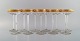 Baccarat, Frankrig. 11 art deco champagneskåle i mundblæst krystalglas med 
gulddekoration i form af blade. 1930
