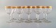 Baccarat, Frankrig. Ti art deco rødvinsglas i mundblæst krystalglas med 
gulddekoration i form af blade. 1930