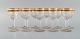 Baccarat, France. 11 art deco white wine glasses in mouth-blown crystal glass 
with gold decoration in the form of leaves. 1930s.
