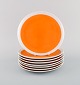 LaGardo Tackett for Schmid. Otte tallerkener i porcelæn. Smuk orange glasur. 
Dateret 1953-56.
