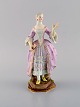 Antique Meissen porcelain figurine. Party-dressed noble lady with fan. Late 19th 
century.
