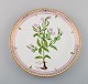 Dinner plate in Flora Danica style. Hand-painted flowers and gold decoration. 
Mid-20th century.
