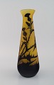 Large antique Emile Gallé vase in yellow and black art glass carved in the form 
of branches with foliage. Rare model. Early 20th century.
