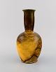 Svend Hammershøi for Kähler, HAK. Narrow neck vase in glazed stoneware. 
Beautiful yellow uranium glaze. 1930s / 40s.
