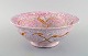 Wilhelm Kåge for Gustavsberg. Early and rare bowl in glazed ceramics. Beautiful 
crackled glaze in pink shades with gold decoration. Dated 1925.
