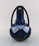 Louis Dage (1885 - 1961), French potter. Large art nouveau vase in glazed 
ceramics and wrought iron mounting with inlaid turquoises. 1920s.
