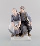 Christian Thomsen (1860-1921) for Royal Copenhagen. Antique and rare porcelain 
figure. Model number 2168. Peasant couple resting. Early 20th century.
